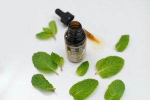 خلطة زيوت لتطويل وتكثيف الشعر 6 bottle surrounded green leaves